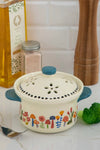 A ceramic, microwaveable vegetable steamer with colorful mushroom print.