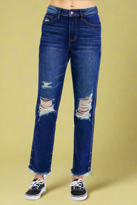 A pair of high waist straight leg jeans in a dark indigo wash by Judy Blue featuring a rigid material front, slight stretch in back, distressed knees and hem, and relaxed fit.