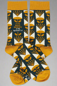 Tall mustard and blue socks that say I’m Not Needy, I’m Wanty.