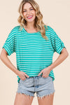 Model is wearing a jade and white striped buttery soft t-shirt in a relaxed fit.