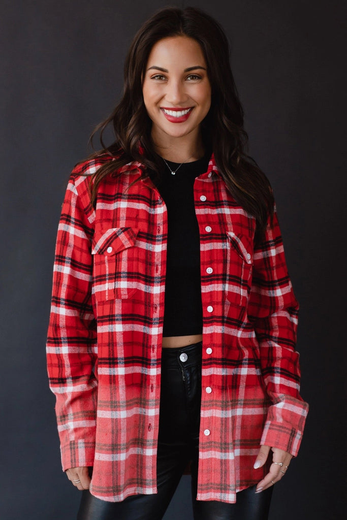 Model is wearing an oversized flannel shirt that features a dyed ombre effect.