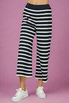 Model is wearing cropped wide leg pants that are ribbed with stretch.