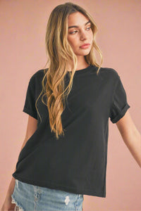 A women’s basic loose fit cotton blend t-shirt in black with crew neck and rolled short sleeves.