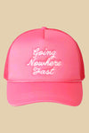 Pink foam front mesh back trucker hat with "Going Nowhere Fast" embroidered across the front in white cursive script. 