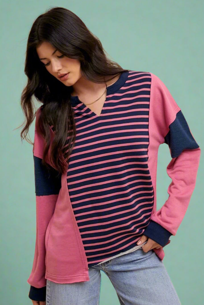 Split neck oversized sweater berry and navy stripes and color block details. Raw hem details throughout, cozy and casual fit. 