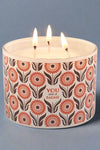 A glass container candle with three wicks in the scent orange blossom. Container says a “You are a badass.”