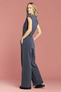 Woman wearing a gray jumpsuit on a white background