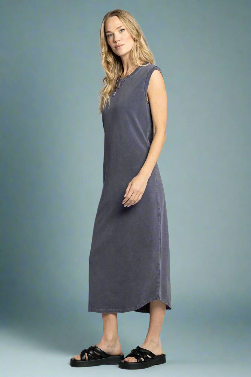 Woman wearing a sleeveless gray dress on a white background