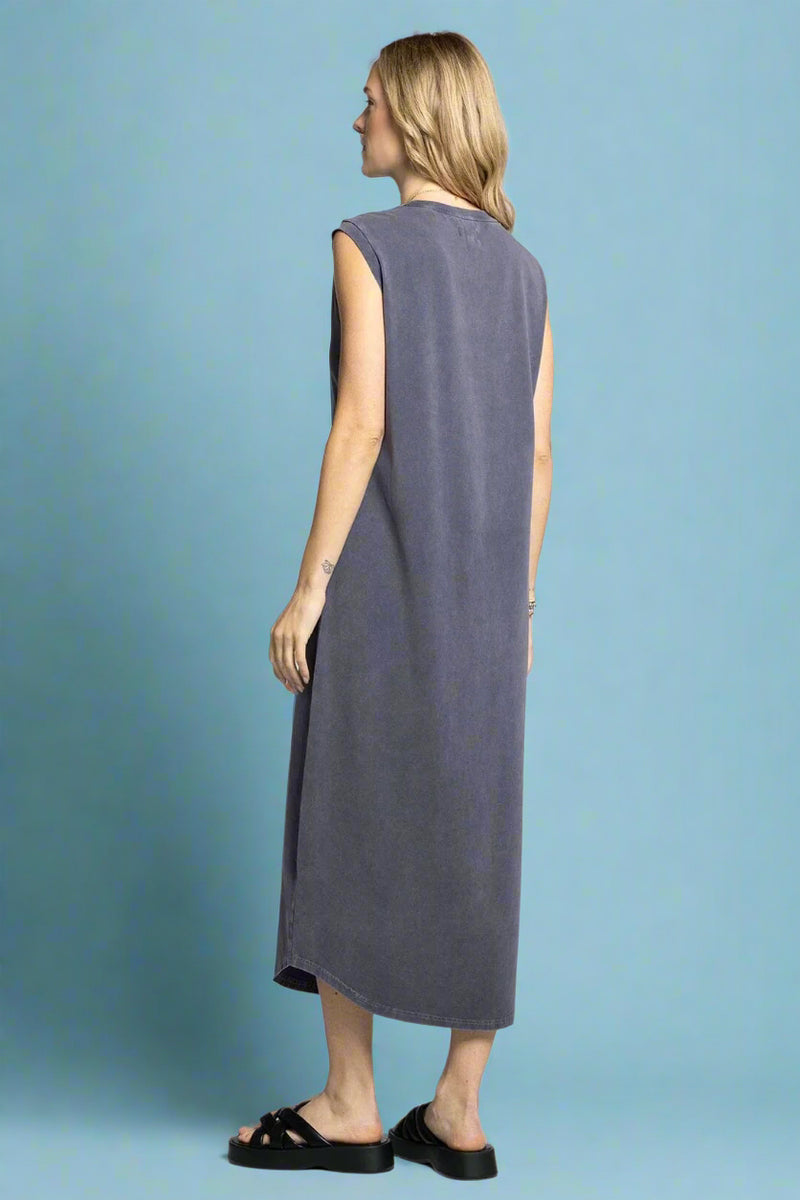 Woman wearing a sleeveless gray dress on a white background