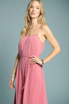 Woman wearing a pink dress against a light gray background