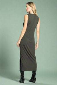 Woman wearing a sleeveless green dress on a white background