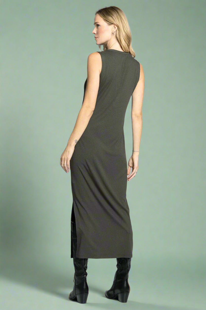 Woman wearing a sleeveless green dress on a white background