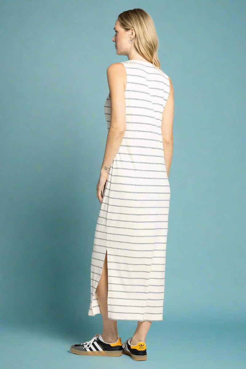 Woman wearing a sleeveless striped dress on a white background