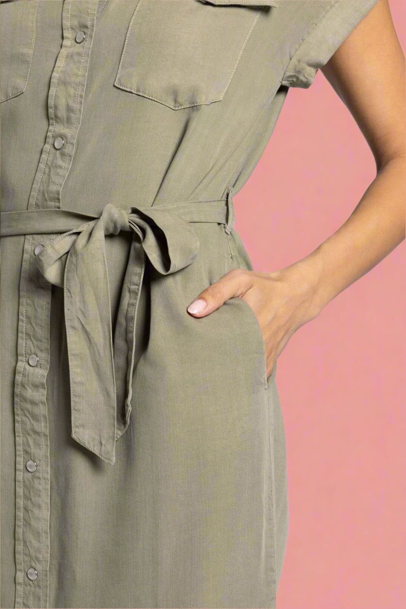 Green dress with a belt on a plain background
