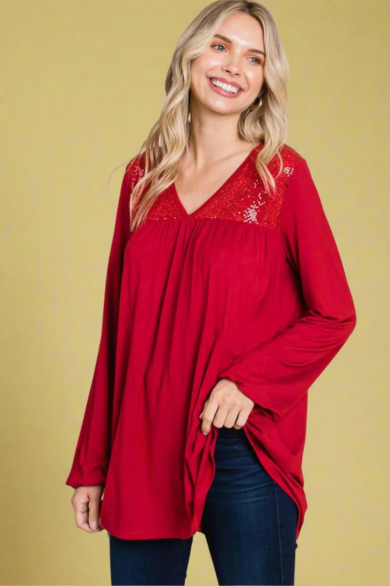 A red long sleeve tunic with sequin detail round the neckline.