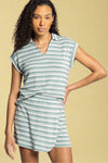 Model is wearing a striped terry cloth collared short sleeve top in light sage green tones. 