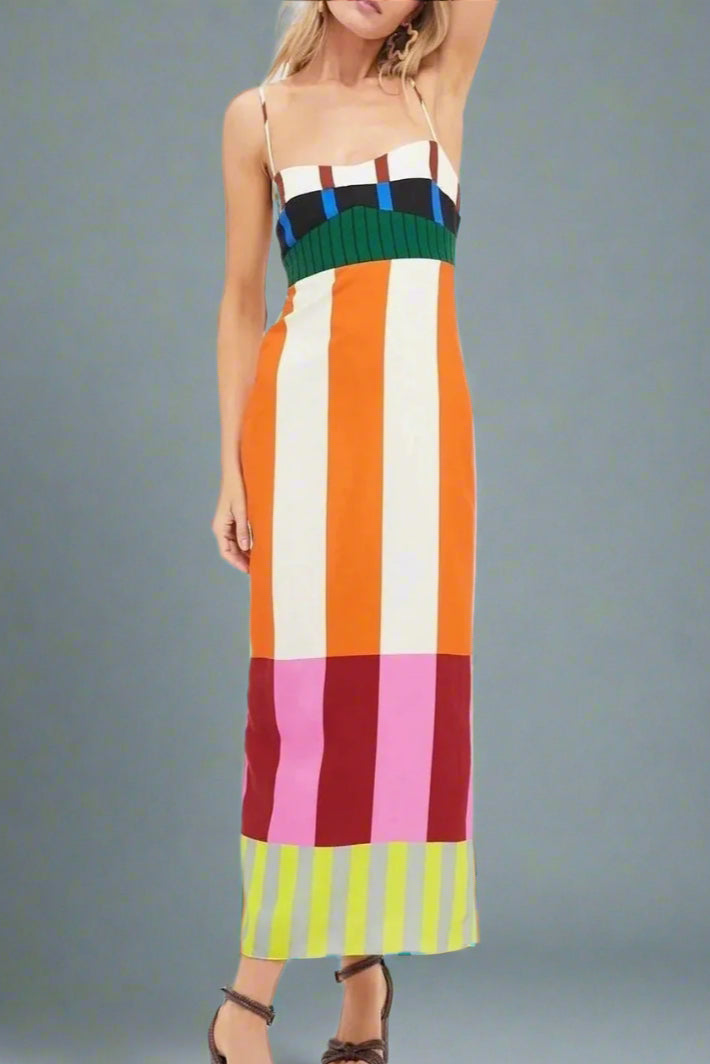 Woman wearing a colorful striped dress on a white background