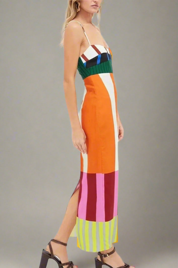 Woman wearing a colorful striped dress on a white background