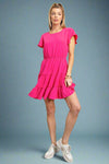 A short sleeve scoop neck mini dress in hot pink with elastic waistband and tiered ruffle skirt.