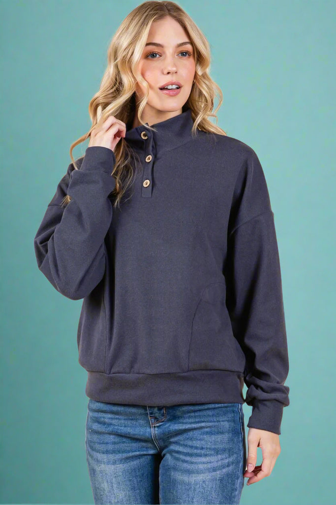 This 1/4 button neck, navy pullover has long sleeves and soft fabric.