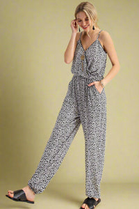 Model is wearing a black and white animal print jumpsuit. 