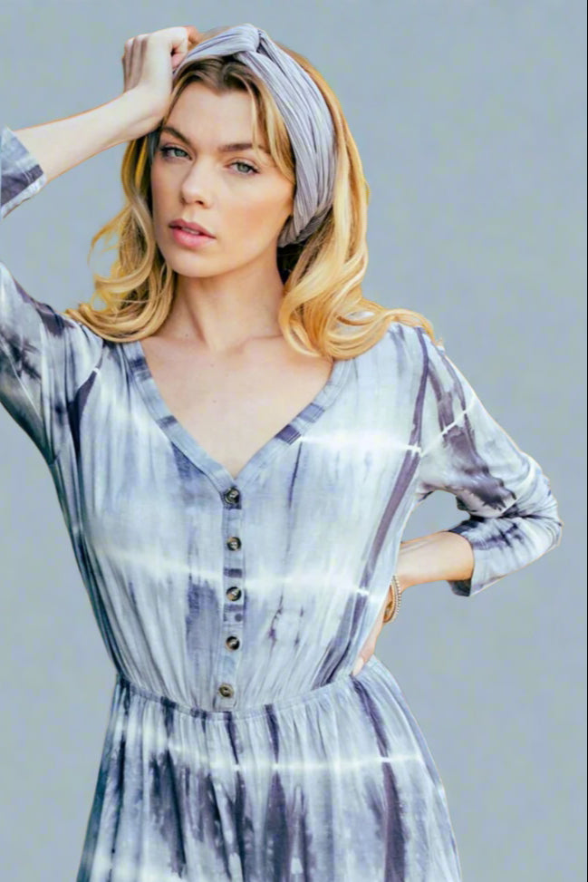 Model is wearing a grey tie dye romper 
