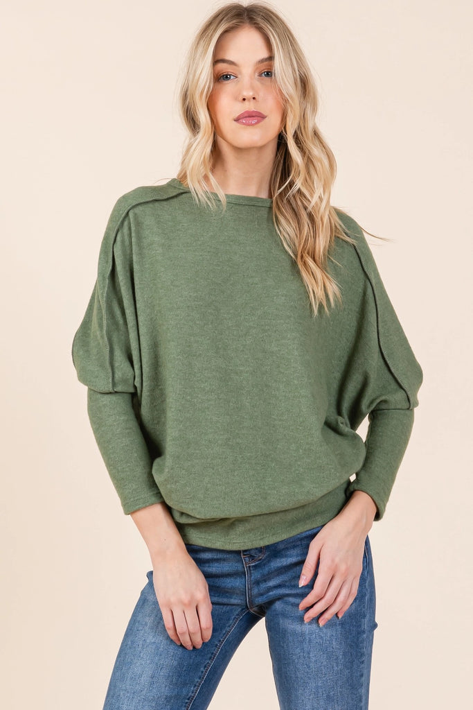 A soft, lightweight dolman sleeve sweater in green.