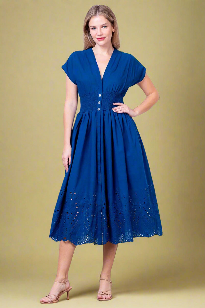 Woman wearing a blue dress against a white background