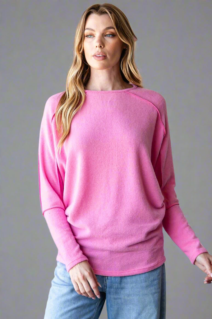 A soft, lightweight dolman sleeve sweater in pink.