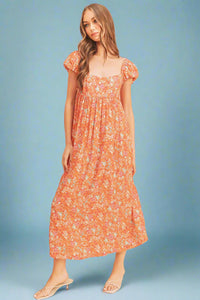 Woman wearing a floral dress on a beige background