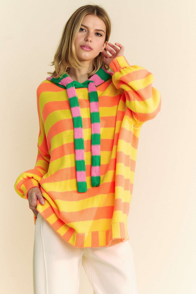 This neon striped, oversized sweater has a hood and long sleeves.