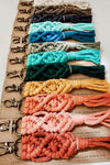 A set of rainbow colored handmade macrame keychains.