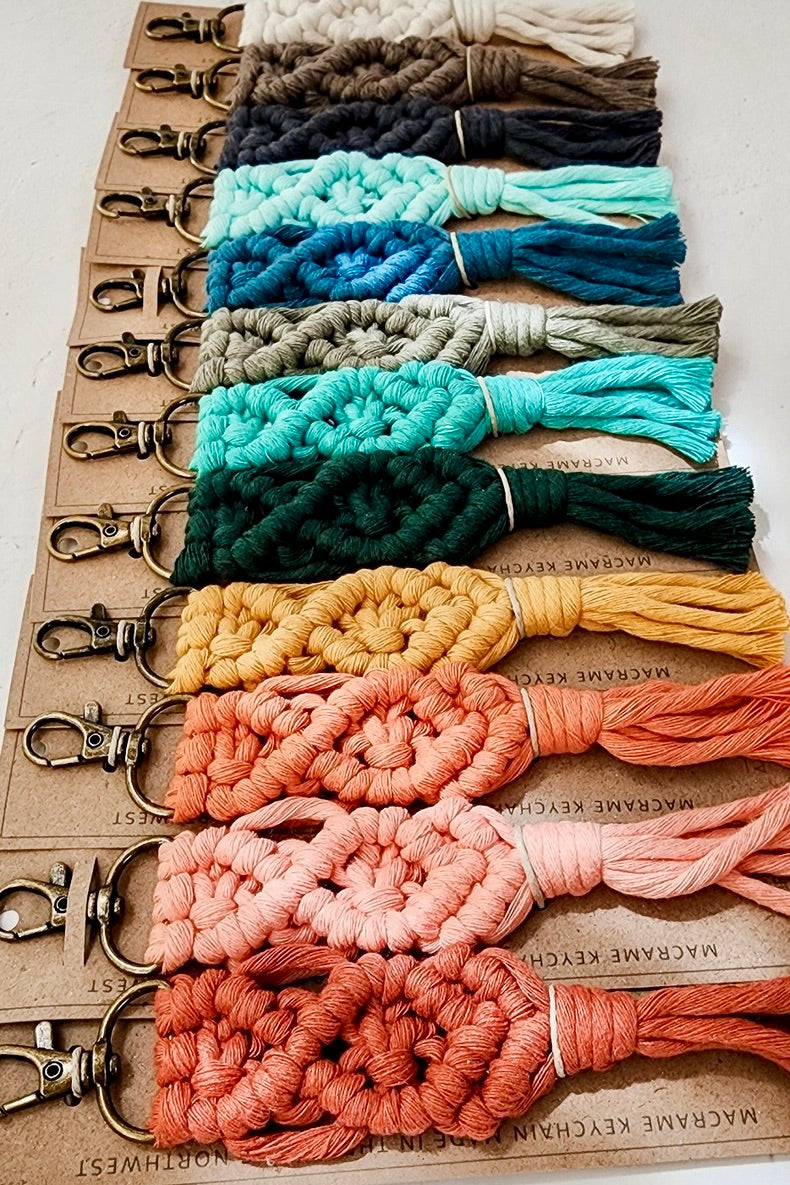 A set of rainbow colored handmade macrame keychains.