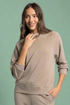 A women’s classic lightweight hooded sweatshirt in buttery soft taupe material and raglan style sleeves.
