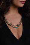 A multi strand necklace in multiple metals. Featuring colorful beaded accents.