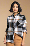 A womens button down flannel in black, grey, white, and camel colors and featuring one chest pocket.