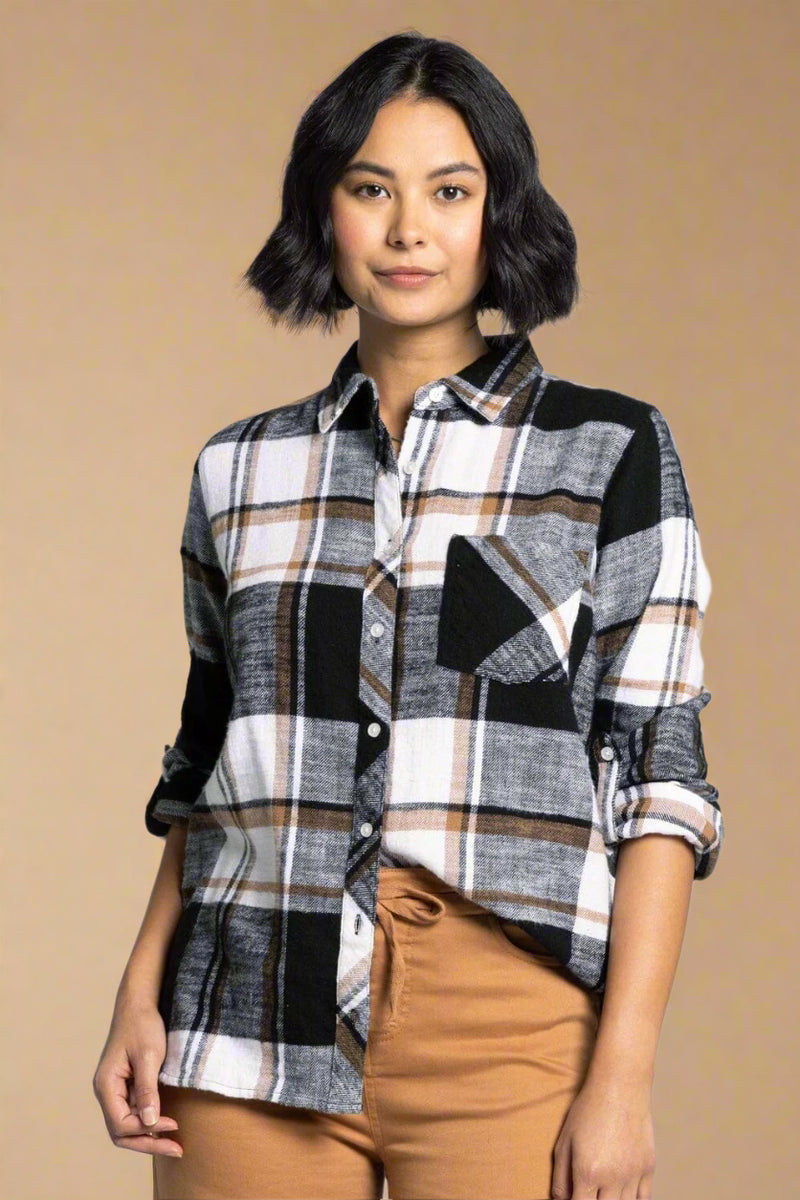 A womens button down flannel in black, grey, white, and camel colors and featuring one chest pocket.