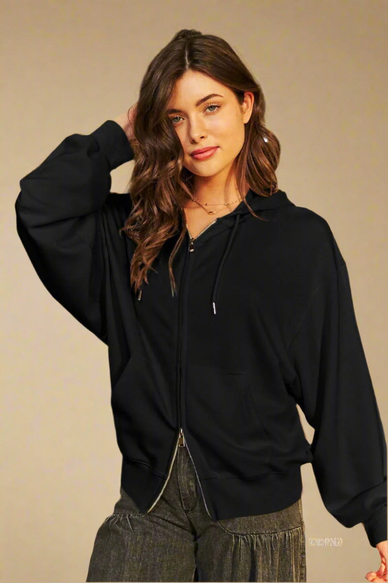 A women’s soft black zip up hoodie featuring double zipper and dolman sleeves.