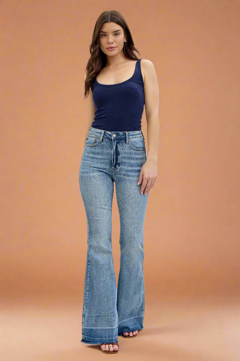 A pair of women’s high-waisted flare leg jeans by Judy Blue with a unique released hem and vintage light wash.
