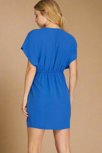 Blue dress worn by a model on a plain background