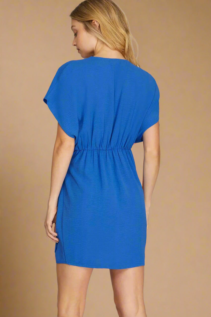 Blue dress worn by a model on a plain background