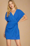 Woman wearing a blue dress on a plain background