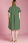 Woman wearing a green dress against a plain background