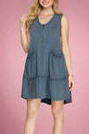 Woman wearing a blue dress on a plain background.