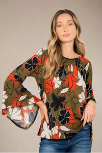  A womens olive color blouse with a keyhole neckline, bell sleeves, and open shoulder accents. This has a floral pattern of green, rust, black and ivory. 