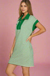 Woman wearing a green and white striped dress on a plain background