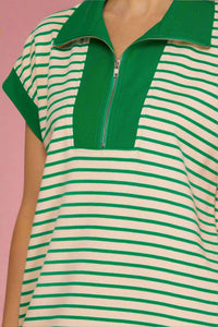 Green and white striped dress with a zipper detail on a plain background