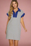 Woman wearing a striped dress with blue accents on a plain background