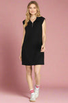 Woman wearing a black sleeveless dress on a plain background