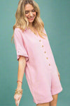 A women’s relaxed fit button down romper featuring a linen blend, v neckline, short rolled sleeves, and front and back pockets in bubblegum pink.